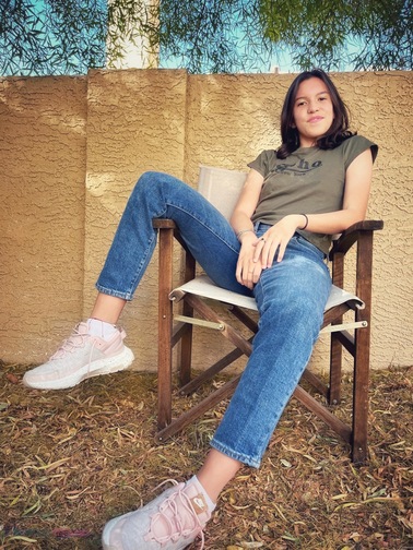 iPhone portraits of a dark haired girl in a green shirt and jeans sitting outside in a chair with her leg over the armrest. Pix Snap Mama is overlaid in the lower left corner